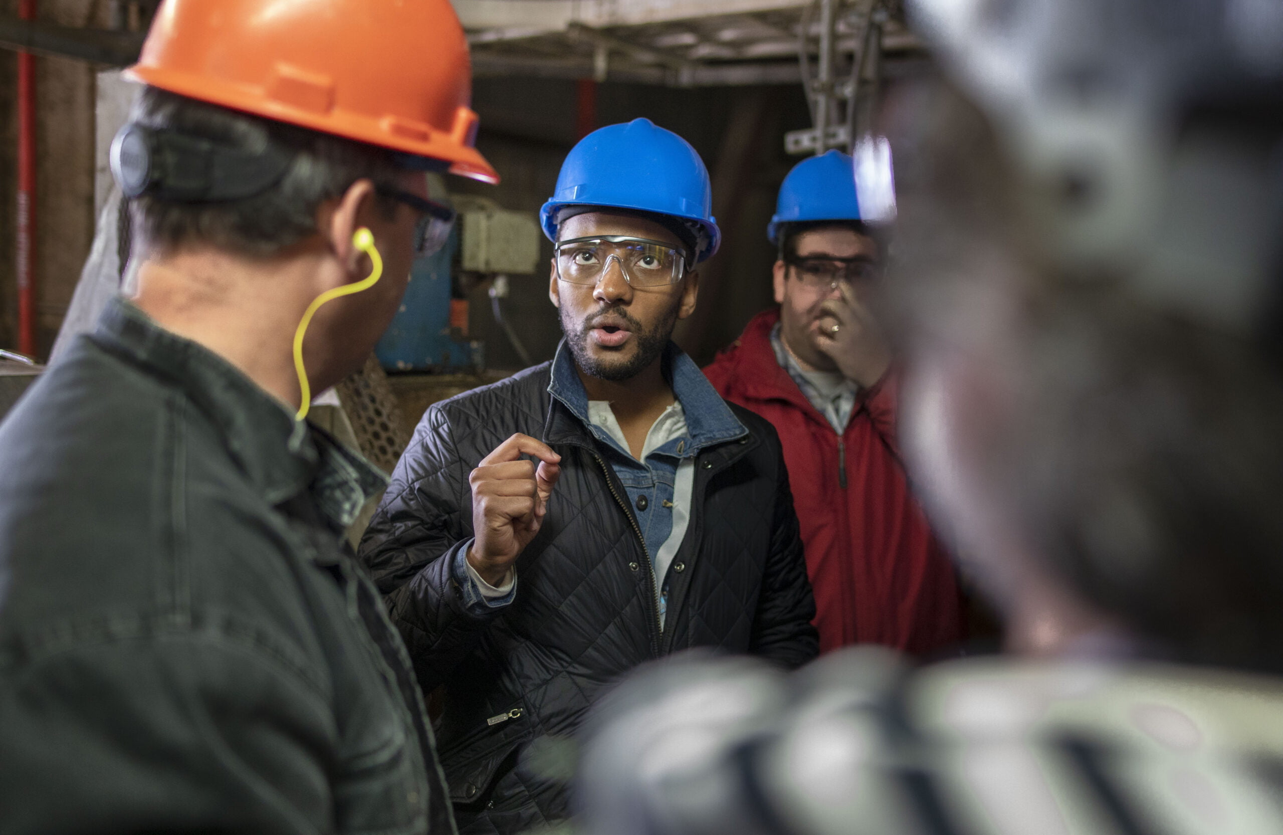 Petros asks a question wearing a hard-hat.