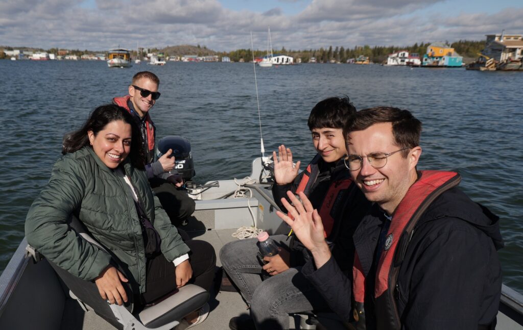 Fellows wave from a boat on Great Slave Lake in Yellowknife.